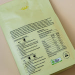 Green package with text and a logo on a beige background